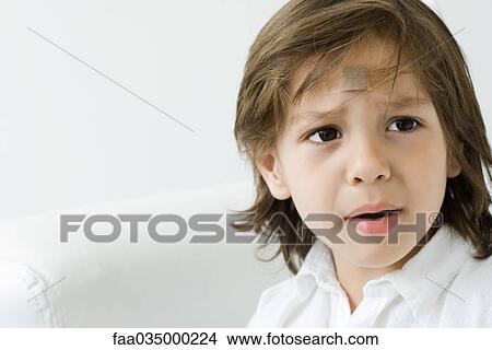 Little boy with adhesive bandage on his forehead, looking away and furrowing brow View Large Photo Image Picture - Little boy with adhesive bandage on his forehead, looking away and furrowing brow. Fotosearch