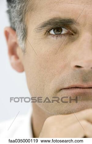 Man holding chin, looking at camera, cropped portrait View Large Photo Image Stock Photo - Man holding chin, looking at camera, cropped portrait. Fotosearch