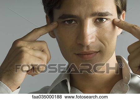 Man pointing at eyes, looking at camera, close-up View Large Photo Image Stock Photo - Man pointing at eyes, looking at camera, close-up. Fotosearch