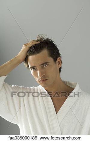 Man running hand through hair, portrait View Large Photo Image Stock Photograph - Man running hand through hair, portrait. Fotosearch