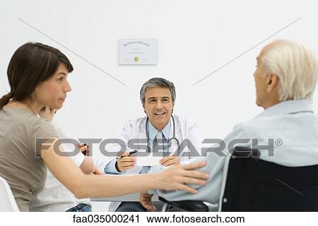 Stock Image - Multi-generational family listening to doctor. Fotosearch