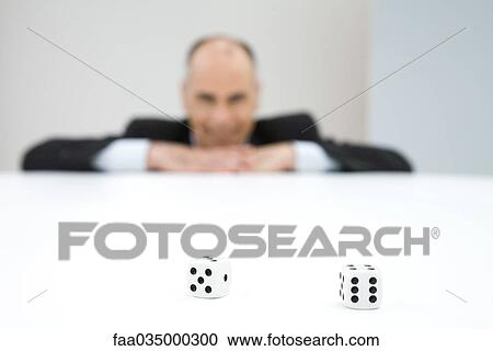 Pair of dice, businessman in background View Large Photo Image Stock Image - Pair of dice, businessman in background. Fotosearch