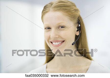 Professional woman wearing headset, smiling, portrait View Large Photo Image Stock Image - Professional woman wearing headset, smiling, portrait. Fotosearch