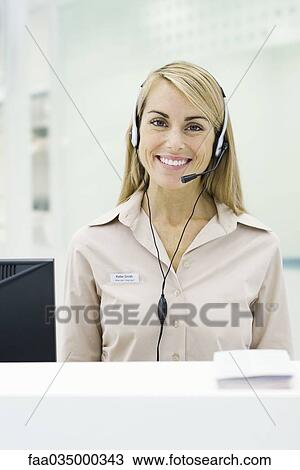 Professional woman wearing headset, smiling at camera View Large Photo Image Stock Image - Professional woman wearing headset, smiling at camera. Fotosearch