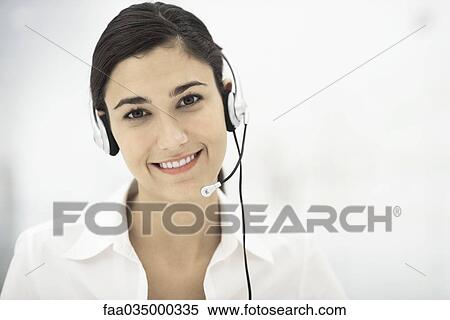 Professional woman wearing headset, smiling, portrait View Large Photo Image Stock Photography - Professional woman wearing headset, smiling, portrait. Fotosearch