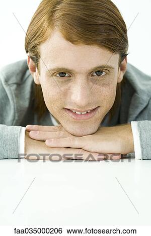 Red-haired man resting chin on hands, smiling, portrait View Large Photo Image Stock Photograph - Red-haired man resting chin on hands, smiling, portrait. Fotosearch
