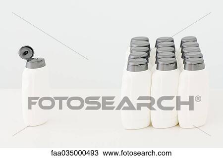 Single plastic bottle with open lid facing group of closed bottles View Large Photo Image Stock Image - Single plastic bottle with open lid facing group of closed bottles. Fotosearch