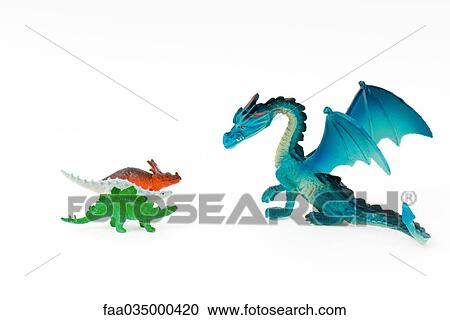 Toy dragon facing three small toy dinosaurs View Large Photo Image Stock Image - Toy dragon facing three small toy dinosaurs. Fotosearch