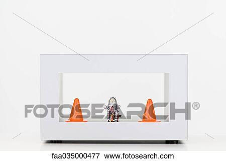 Toy robot between two traffic cones View Large Photo Image Stock Photo - Toy robot between two traffic cones. Fotosearch