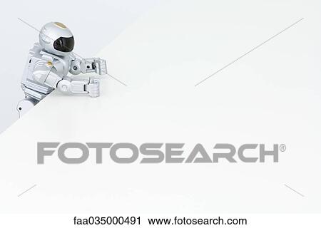 Toy robot hanging on to edge of table View Large Photo Image Stock Image - Toy robot hanging on to edge of table. Fotosearch