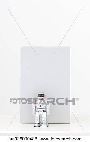 Toy robot in front of gray rectangle View Large Photo Image Stock Photo - Toy robot in front of gray rectangle. Fotosearch