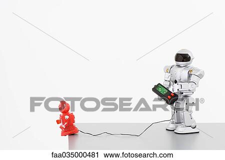 Toy robot playing with remote control robot View Large Photo Image Stock Image - Toy robot playing with remote control robot. Fotosearch