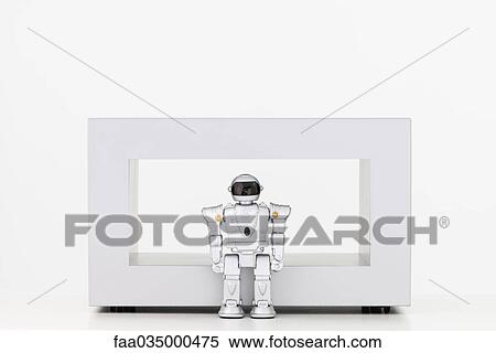 Toy robot standing in front of coffee table View Large Photo Image Stock Photography - Toy robot standing in front of coffee table. Fotosearch
