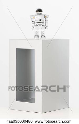Toy robot standing on top of box View Large Photo Image Stock Photograph - Toy robot standing on top of box. Fotosearch
