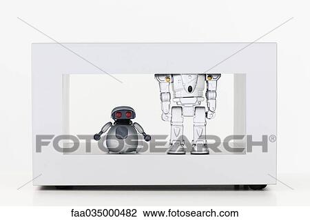 Toy robots standing side by side, one short and the other tall View Large Photo Image Stock Image - Toy robots standing side by side, one short and the other tall. Fotosearch