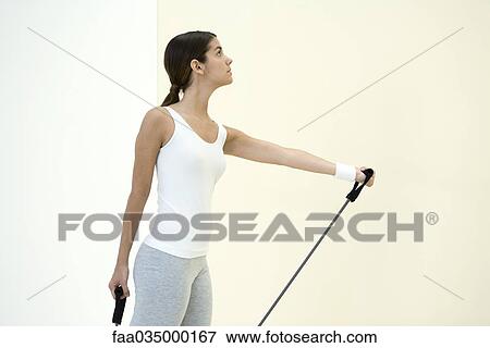 Woman exercising with resistance band View Large Photo Image Stock Photo - Woman exercising with resistance band. Fotosearch