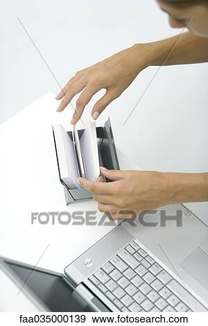 Woman flipping through card file, high angle view View Large Photo Image Stock Photo - Woman flipping through card file, high angle view. Fotosearch