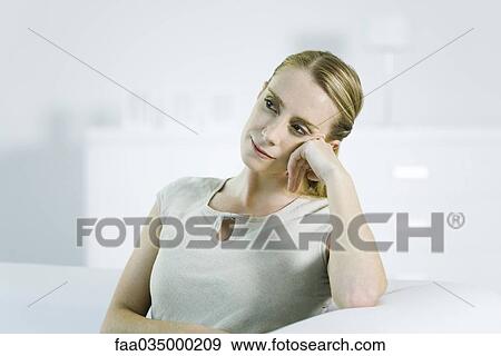 Woman leaning on elbow, looking away View Large Photo Image Stock Photo - Woman leaning on elbow, looking away. Fotosearch