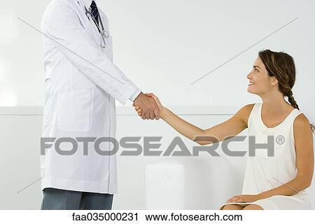 Woman shaking hands with doctor, cropped view View Large Photo Image Stock Image - Woman shaking hands with doctor, cropped view. Fotosearch