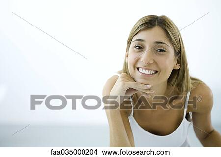 Woman smiling at camera, portrait View Large Photo Image Picture - Woman smiling at camera, portrait. Fotosearch