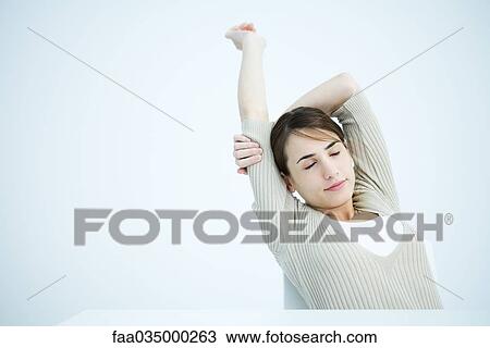 Woman stretching arms, eyes closed View Large Photo Image Stock Image - Woman stretching arms, eyes closed. Fotosearch