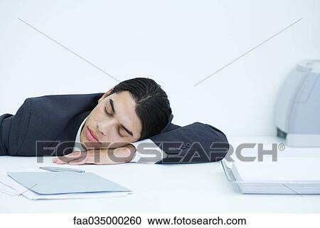 Young businessman napping at desk View Large Photo Image Stock Image - Young businessman napping at desk. Fotosearch