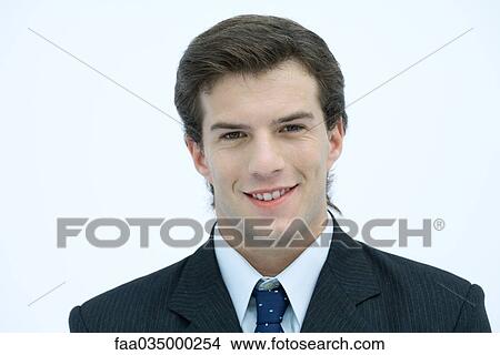 Picture - Young businessman smiling at camera, portrait. Fotosearch