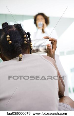 Young girl and woman playing with tin can phone View Large Photo Image Stock Photograph - Young girl and woman playing with tin can phone. Fotosearch