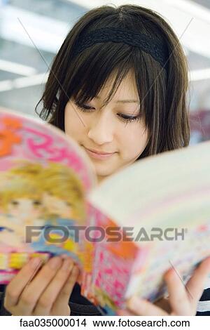 Young Japanese woman reading manga-style comic book View Large Photo Image Picture - Young Japanese woman reading manga-style comic book. Fotosearch