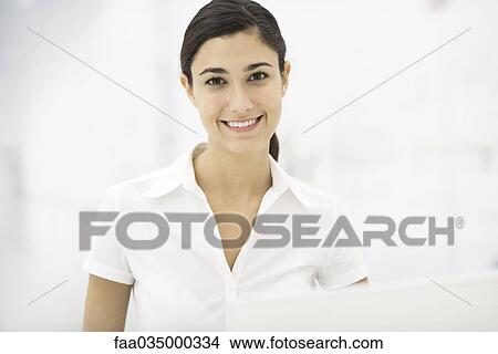 Young professional woman smiling at camera, portrait View Large Photo Image Picture - Young professional woman smiling at camera, portrait. Fotosearch