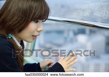 Young woman on Ferris wheel, looking out window View Large Photo Image Picture - Young woman on Ferris wheel, looking out window. Fotosearch
