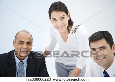 Business associates smiling at camera, portrait View Large Photo Image Stock Image - Business associates smiling at camera, portrait. Fotosearch