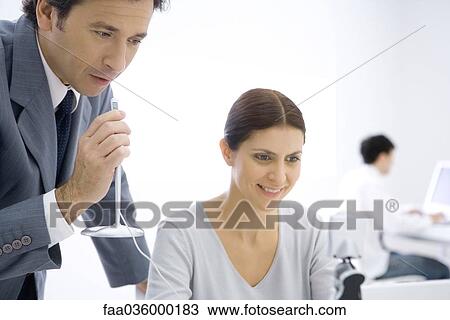 Stock Image - Business associates teleconferencing in office. Fotosearch
