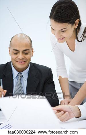 Business associates working together, smiling View Large Photo Image Picture - Business associates working together, smiling. Fotosearch