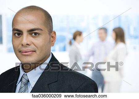 Businessman looking at camera, portrait View Large Photo Image Stock Photo - Businessman looking at camera, portrait. Fotosearch