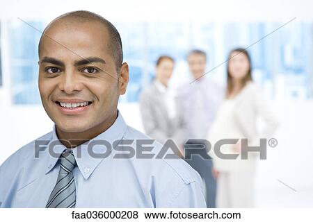 Stock Photo - Businessman smiling at camera, portrait. Fotosearch