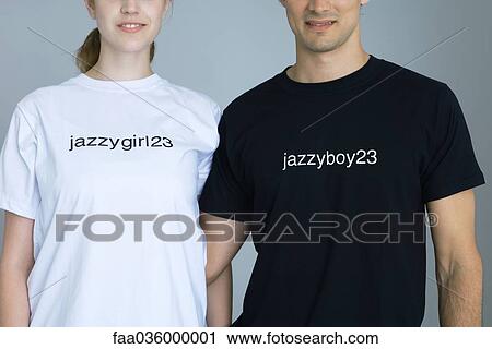 Couple wearing customized tee-shirts, smiling, cropped view View Large Photo Image Stock Image - Couple wearing customized tee-shirts, smiling, cropped view. Fotosearch