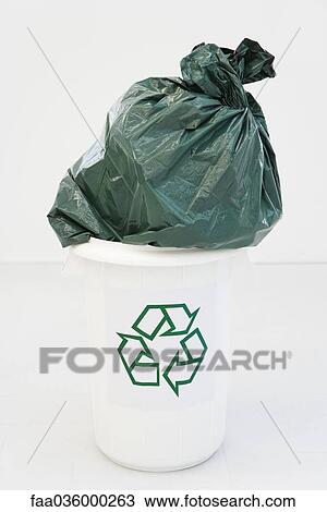 Excessively large garbage bag stuffed partially into recycling bin View Large Photo Image Stock Image - Excessively large garbage bag stuffed partially into recycling bin. Fotosearch