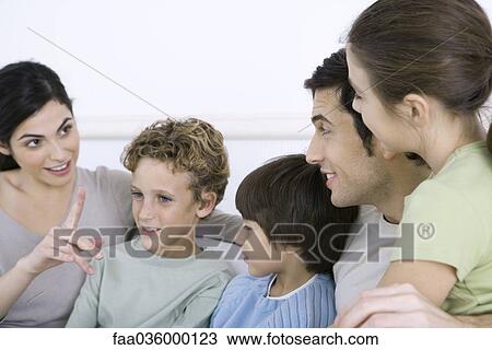 Family sitting together, having a discussion View Large Photo Image Stock Image - Family sitting together, having a discussion. Fotosearch