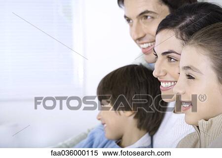 Family sitting together, looking away, side view View Large Photo Image Stock Photography - Family sitting together, looking away, side view. Fotosearch