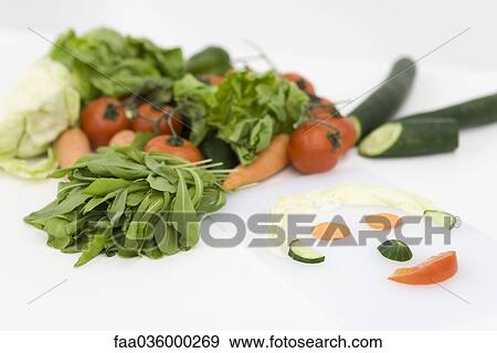 Fresh vegetable slices arranged in shape of face, close-up View Large Photo Image Stock Photo - Fresh vegetable slices arranged in shape of face, close-up. Fotosearch