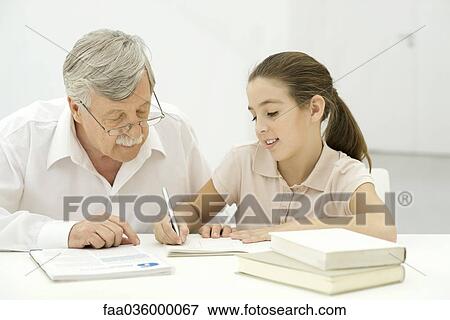 Grandfather helping granddaughter with homework View Large Photo Image Stock Photo - Grandfather helping granddaughter with homework. Fotosearch