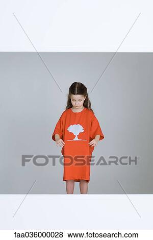 Little girl wearing tee-shirt with mushroom cloud printed on it View Large Photo Image Stock Photo - Little girl wearing tee-shirt with mushroom cloud printed on it. Fotosearch