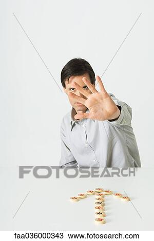 Man holding open palm toward camera, Chinese chess pieces in shape of arrow pointing to him View Large Photo Image Stock Image - Man holding open palm toward camera, Chinese chess pieces in shape of arrow pointing to him. Fotosearch