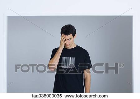 Man wearing tee-shirt printed with bar code, covering face with hand View Large Photo Image Stock Photography - Man wearing tee-shirt printed with bar code, covering face with hand. Fotosearch
