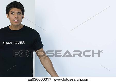 Stock Photo - Man wearing tee-shirt printed with the words "game over". Fotosearch