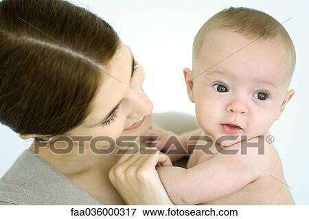 Mother holding infant, baby looking away View Large Photo Image Stock Photo - Mother holding infant, baby looking away. Fotosearch