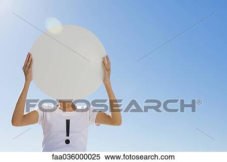 Person wearing tee-shirt printed with exclamation mark, holding large circle in front of face View Large Photo Image Stock Photography - Person wearing tee-shirt printed with exclamation mark, holding large circle in front of face. Fotosearch