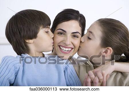 Portrait of smiling mother being kissed on each cheek by daughter and son View Large Photo Image Stock Image - Portrait of smiling mother being kissed on each cheek by daughter and son. Fotosearch