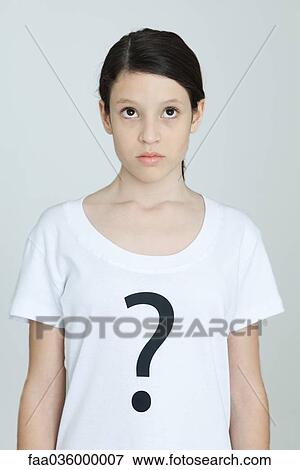 Preteen girl wearing tee-shirt printed with question mark, looking up, portrait View Large Photo Image Stock Photo - Preteen girl wearing tee-shirt printed with question mark, looking up, portrait. Fotosearch